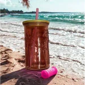 Drinking Glass with Palm Tree Design and Pink Straw for Beachside Refreshments