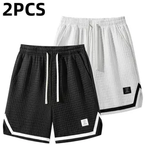 Two men’s casual shorts featuring a waffle texture and drawstring design in contrasting colors. Trendy sporty style with a pure white waffle texture as the main color for a fresh, sophisticated look. Elastic drawstring waistband that fits snugly. Large si
