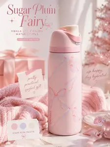 Owala FreeSip Stainless Steel Water Bottle in the "Sugar Plum Fairy" colorway, featuring a soft pink finish with a whimsical bow pattern
