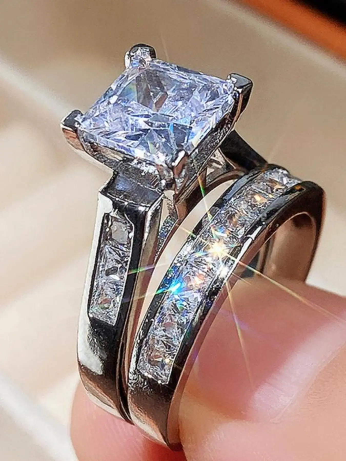 2-Piece Princess Cut Zircon Ring Set, Gold & Silver. Brilliant square-cut center stone with a matching eternity band. Perfect as an engagement ring, wedding band, or promise ring for her. A timeless bridal jewelry must-have!