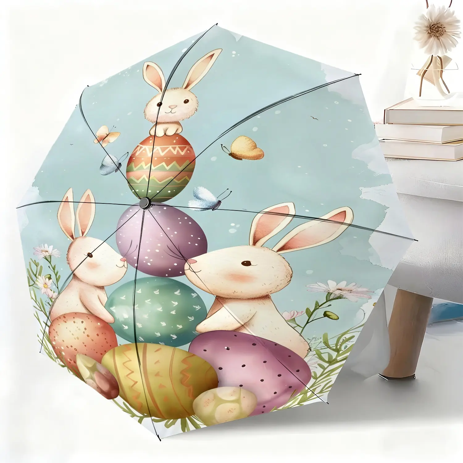This waterproof folding umbrella features colorful rabbit, egg, flower, and butterfly decorative patterns. Suitable for both men and women, it's portable and perfect for travel and everyday use.