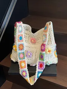 Fashionable and gentle woven tote bag with openwork mesh texture, three-dimensional floral decorations, rainbow-painted shoulder straps, and a beige base color. Essential for daily commutes and outings