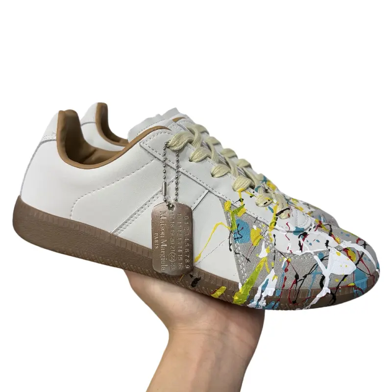 Suede low‑top artistic retro sneakers black multicolor paint‑splatter art print, lace‑up gum rubber outsole unique street casual footwear