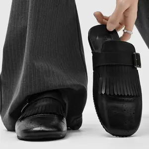 Men’s Fringed Brogue Leather Mules with adjustable buckle strap. Perforated toe details and retro tassel fringe create vintage style. Soft premium leather delivers all‑day comfort, perfect for wide‑leg trousers, slacks and casual street daily styling.