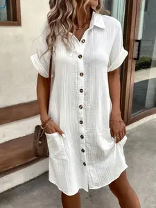 A simple white shirt dress made of breathable fabric, featuring a pointed collar and neatly arranged buttons, adds a touch of vintage charm