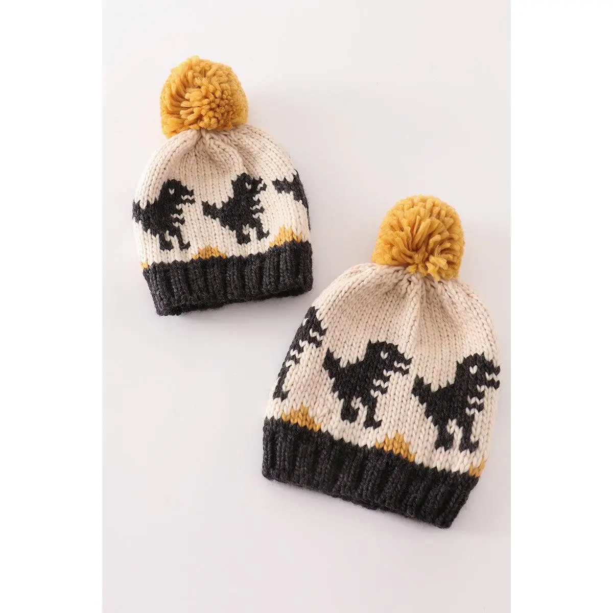 Black pompom dinosaur cable beanie
