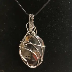 Calico colored jasper pendant in silver wire wrapping