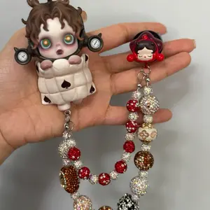 Beaded charm decorated with Skull Panda blind box figurine for car vent.