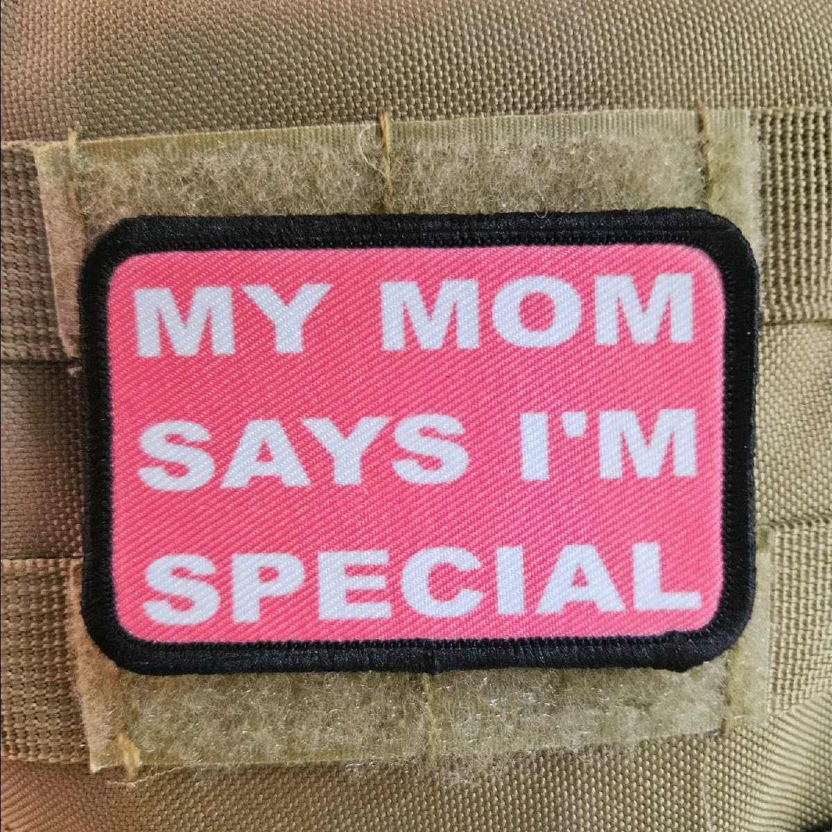 pink my mom says i'm special funny 2"x3" morale patch with hook and loop backing background