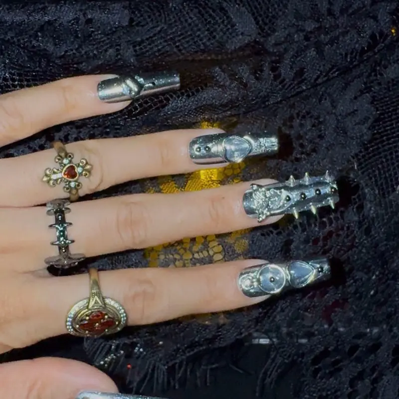 Women's Full Elongated Gothic Press-On Nails - Chrome Silver Handpainted Punk Metal Fake Nails, Long Coughing Shape with Sharp Spikes, Dripping Hearts, Cross, Butterfly Crystals, Stone Ornaments, Reusable, Emo, Ideal for Holiday Rave Concerts