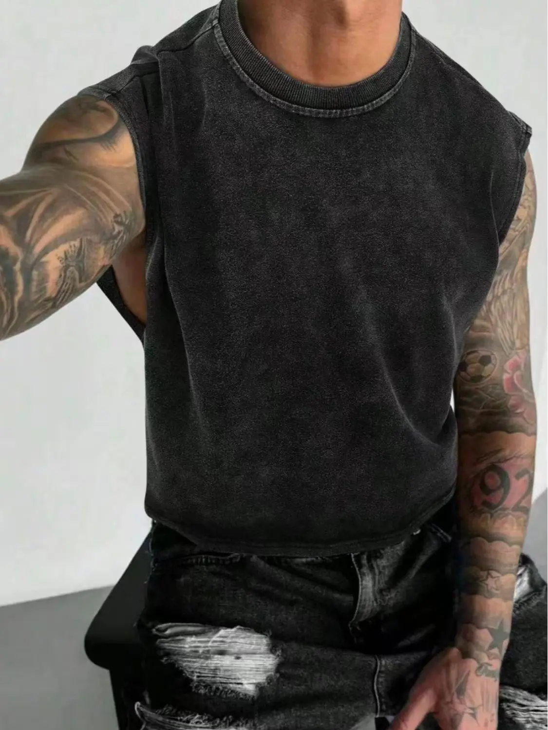 One piece men’s distressed crew neck tank top, street cool style with a washed, aged texture that adds retro appeal. The crew neckline fits snugly around the neck without feeling tight, and the sleeveless design is light and streamlined. Made from soft, s