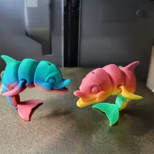 Balancing rainbow Dolphin figurines