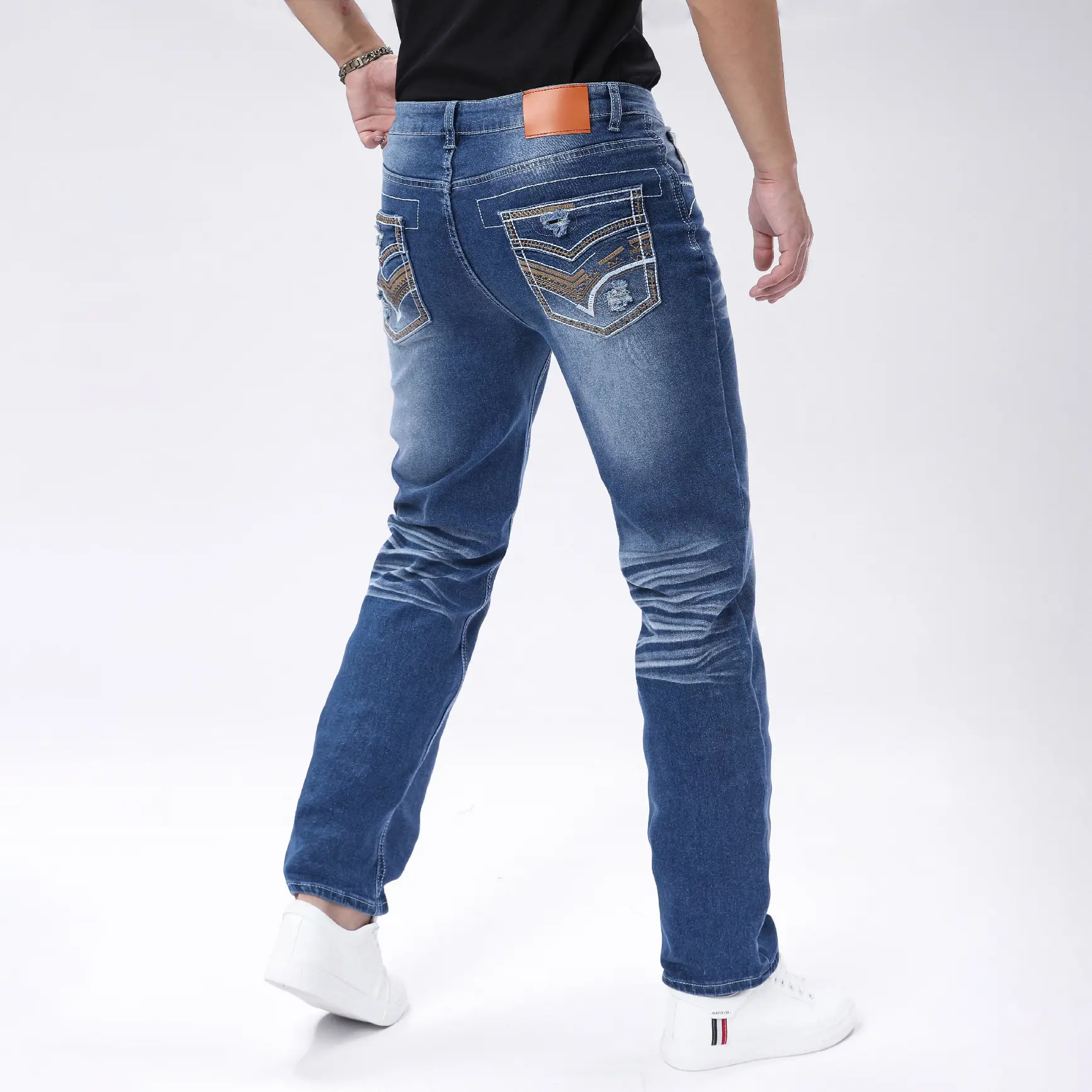 Men’s vintage washed stretch denim jeans with a minimalist, premium fit, distressed “cat whisker” rubbing technique, and refined topstitching—versatile for biker, street, and casual outfits.