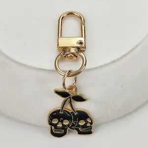 1/20pcs Gothic Cherry Skull Keychain – Golden-Tone Zinc Alloy Pendant with Black Enamel Skulls & Cherry Design, Edgy Men’s Car Key Accessory, Cool Keychains, Backpack Charm, Fashion Gift for Halloween or Birthdays, Bag Accessory