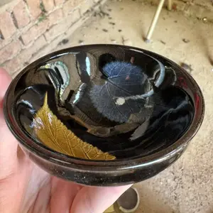 Handmade Jianzhan Teacup: Dual - Leaf Artistry on Glossy Black Glaze