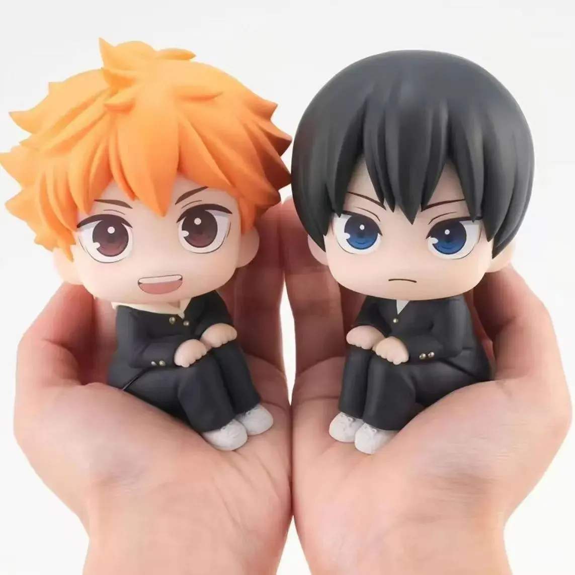 Chibi-style figures of Tobio Kageyama and Shoyo Hinata (seated poses)—PVC models/display figures, anime merchandise.