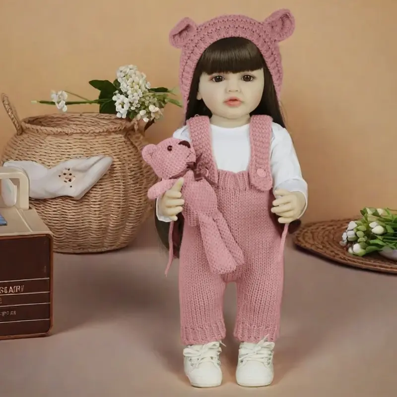 22-inch realistic princess doll with brown long hair and a pink jumpsuit – silicone doll, fully articulated girl with teddy bear and accessories, suitable as a Christmas gift, birthday present, and for collectors.