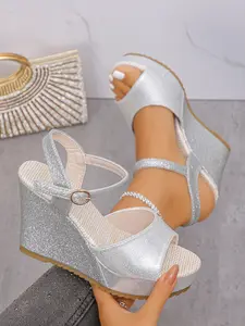 A pair of versatile glitter ankle-strap wedge sandals with ergonomic cushioned insole and stable thick wedge, flexible buckle optimizes wearing tightness. Great for neighborhood strolls and errands to freely match all kinds of casual daily bottoms.