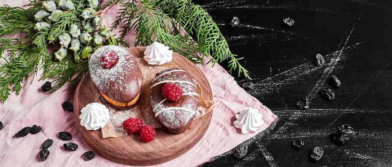 Homemade pastries topped with cream and raspberries