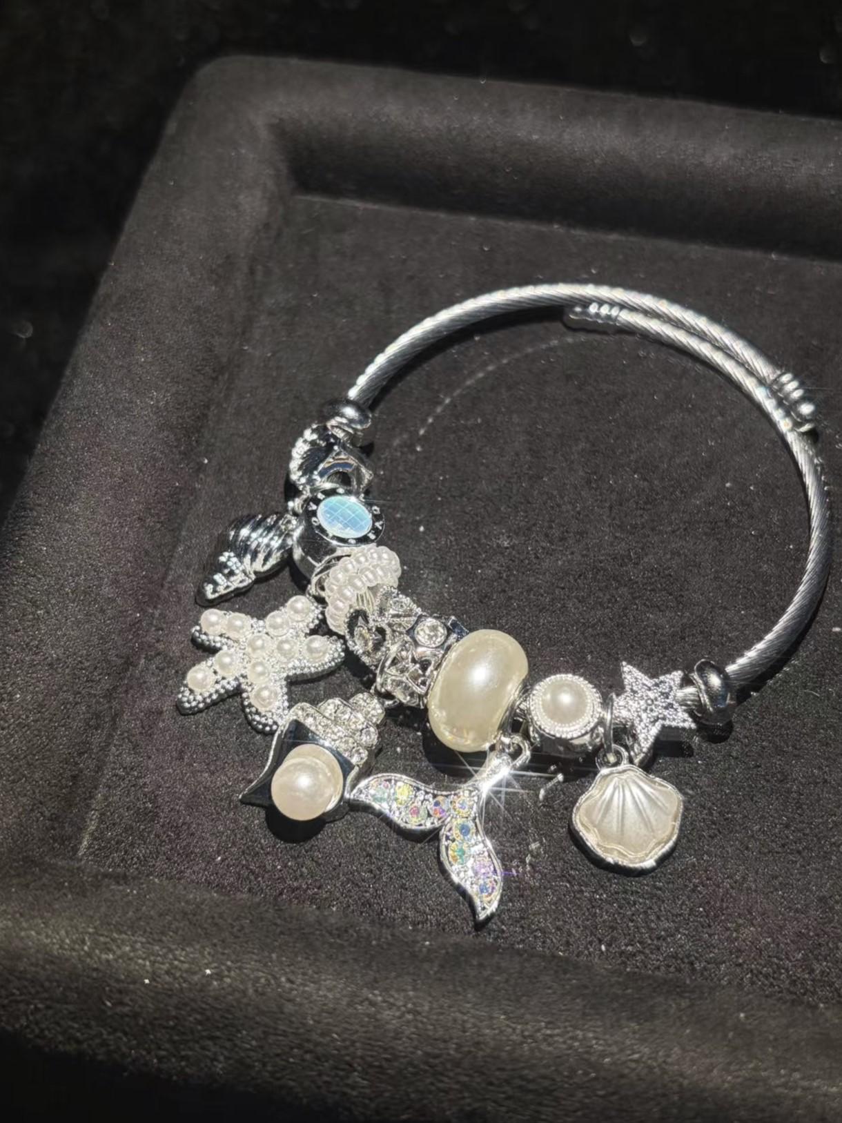 Silver-Tone Open Twist Wire Cuff Bangle, Sparkly Ocean Theme Charm Bracelet with Mermaid Tail, Starfish, Shell, Pearl Charms, Stackable Summer Holiday Costume Jewelry for Gifting Silver-Tone Open Twist Wire Cuff Bangle, Sparkly Ocean Theme Charm Bracelet with Mermaid Tail, Starfish, Shell, Pearl Charms, Stackable Summer Holiday Costume Jewelry for Gifting