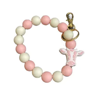Fashionable Car Keyring / Handcrafted Beaded Wristlet Keychain with a cow-print charm and gold key ring & clasp.These wristlets are popular accessories designed to be worn on the wrist, keeping keys easily accessible. Makes cute purse charm as well.