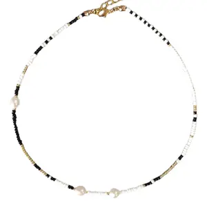 Black and White Pukas Necklace with Black and White Beaded Strap and Decorative Elements