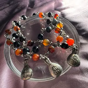 Money Bag Bracelet with Black and Orange Beads, Decorative Pendants, and Silver-Tone Finish