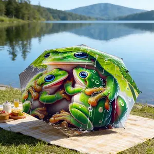 Portable folding umbrella The umbrella features a vivid pattern of three green frogs with large blue eyes, embraced together among raindrops. Suitable for daily travel use, holiday Gift