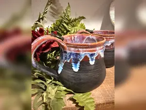 Black and purples stoneware mug .