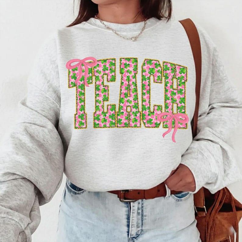 St Patrick Shamrock TEACH Coquette Bow Sweatshirt, Pink Green Teach Shirt, St Patrick’s Day Teacher Gift, Lucky Teacher