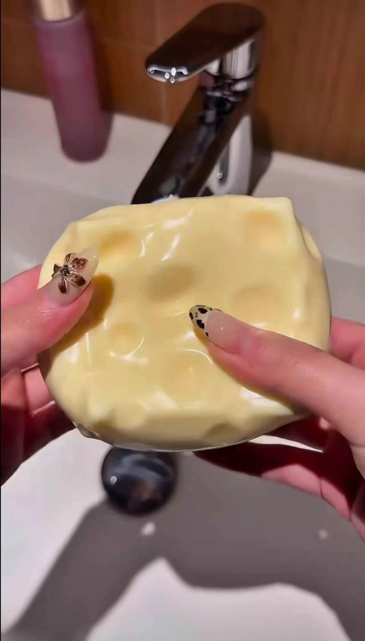 Soft and adorable cheese-shaped squishy toy—a yellow, moldable stress reliever designed for squeezing. Featuring a highly pliable, non-rebounding texture, this slow-rising squishy serves as an ASMR stress ball and a fun tool for hand strength training.