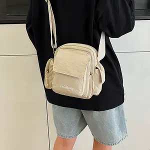 Nylon fabric lightweight waterproof multi-pocket camera bag, unisex shoulder bag, versatile crossbody bag.