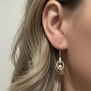 Beautiful Gold-Tone Dangle Earrings with Intricate Design and Sparkling Center Stone for Elegant Looks