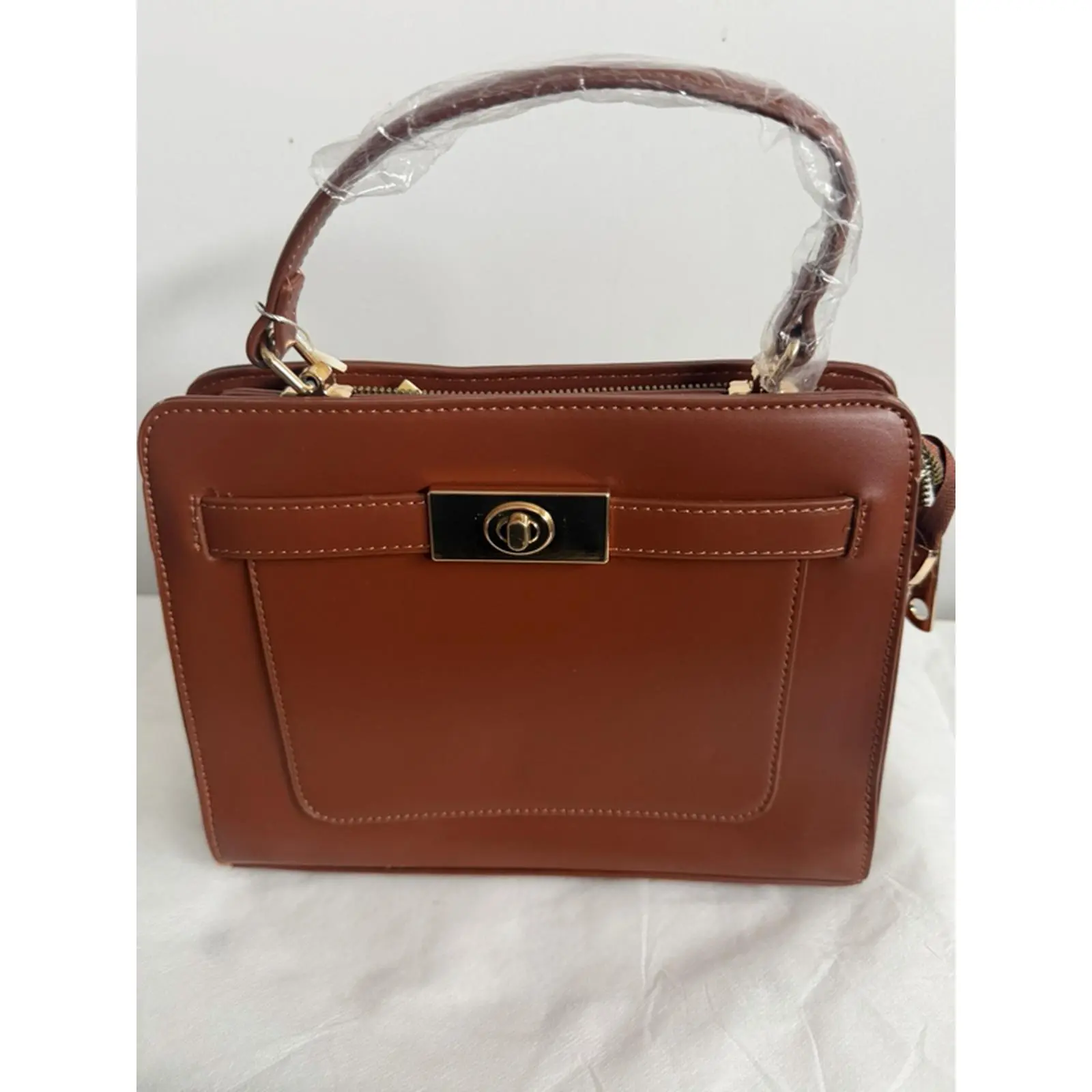 Elegant Brown Leather Handbag with Gold Hardware and Zip Closure