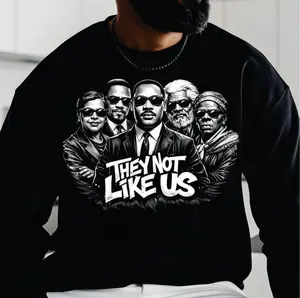 They Not Like Us Sweatshirt - Bold White Lettering on Black, Stylized Figures in Dark Suits, Modern Streetwear Aesthetic