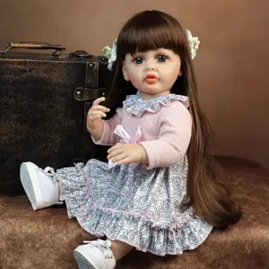 KEIUMI Betty Realistic Reborn Baby Dolls - 22in Full Silicone Baby Girl, Long Brown Hair, Blue Eyes, Pink Bow Floral Dress, White Canvas Shoes, Bonus: Rose Dress, Pearl Headband, Lace Socks, Gift for Kids 3+ (Birthday, Christmas)