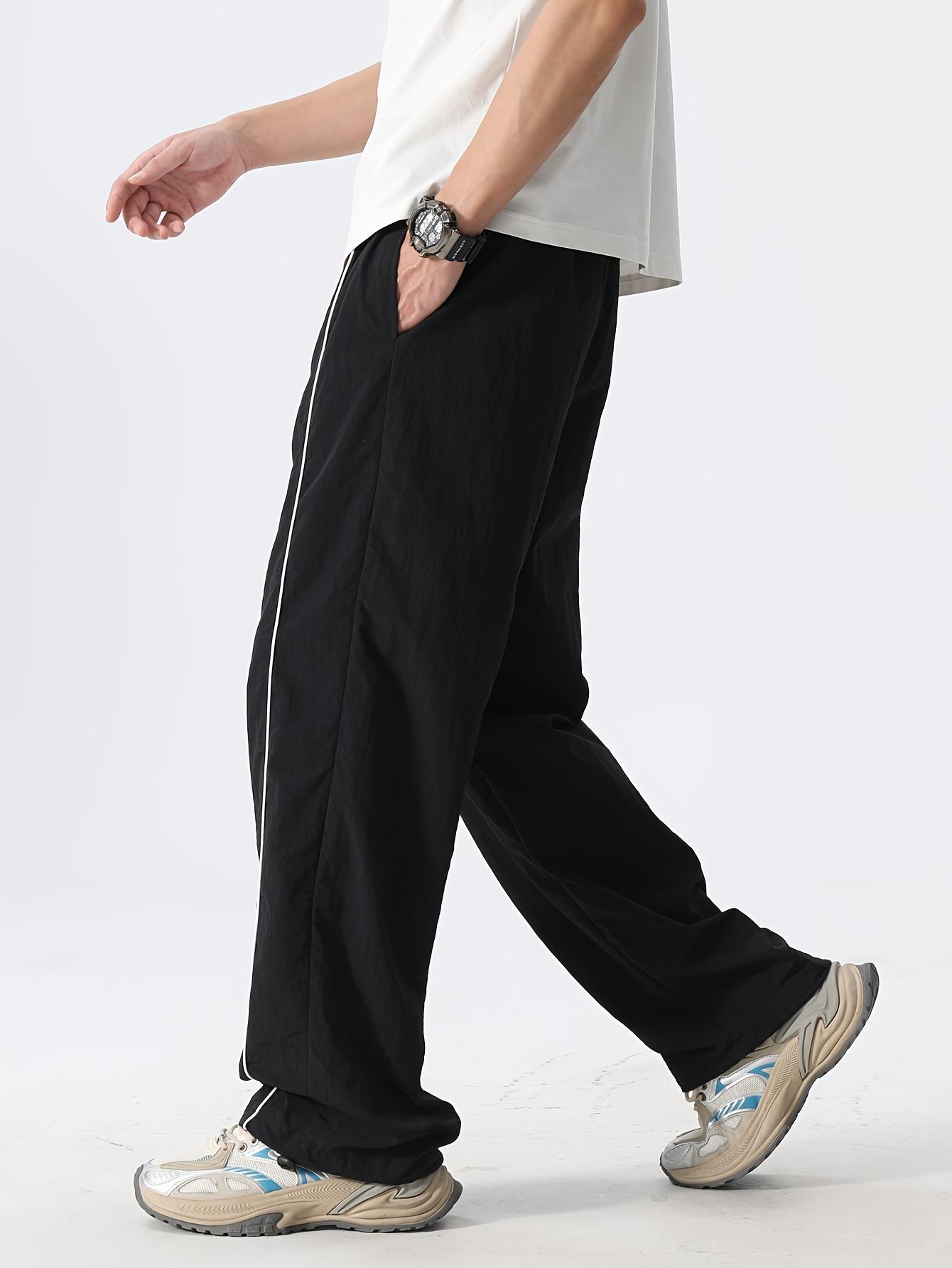 Men’s fashion loose fit long pants with side stripe paneling, drawstring waist, and elastic cuffs—perfect for everyday casual wear.