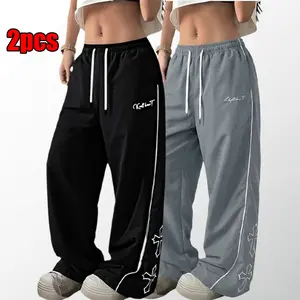 Women’s lightweight loose-fit joggers with a soft feel and a relaxed silhouette; gray jogger pants with a cross print on the side; comfortable athletic casual bottoms for gym wear; unisex design.