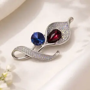 Elegant silver flower brooch with sparkling blue crystals — a delicate and timeless accessory that adds sophistication to any outfit.