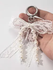 Niche design sweet style lace pearl bow keychain, fashionable and exquisite keychain bag pendant, small and versatile imitation pearl lace bow pendant, fashionable and leisure bag car keychain pendant, Bag charm keychain