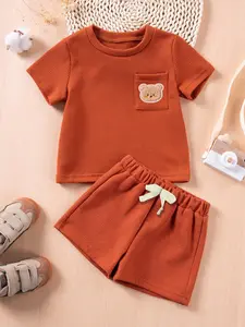 Baby's 2pcs Cartoon Bear Patched Textured Short Sleeve T-Shirt & Bow Decor Shorts Set, National Day Offers, Cute Pocket Round Neck Tee & Elastic Waist Shorts, Casual Summer Outfits Clothes for Infant Toddler Boys, Baby Clothing