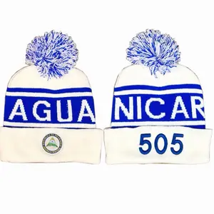 Beanie Nicaragua's Agu 505 Beanie with Blue Pom Pom and White Knit Design