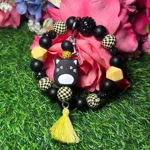 Bad luck  wristlet in the color scheme dark yellow checkered print, black and bling beads made with wire