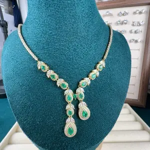 <PingEast jewelry > 925 Sterling Silver Necklace in Gold-Tone, set with 12 pear-shaped natural deep green emeralds in a feather design, with diamonds, certified