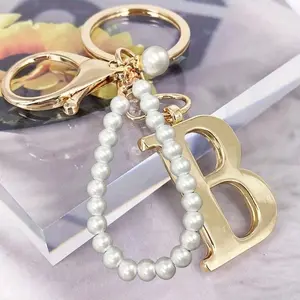 Advanced Elegant Golden Pearl Letter Keychain, Letters A-Z Three-Dimensional Pendant, Elegant Pearl Chain Flash Diamond (Removable According To Personal Preference) Fashion Alloy Keychain Ring, Earphone Pendant, Backpack Charm Car Keychain