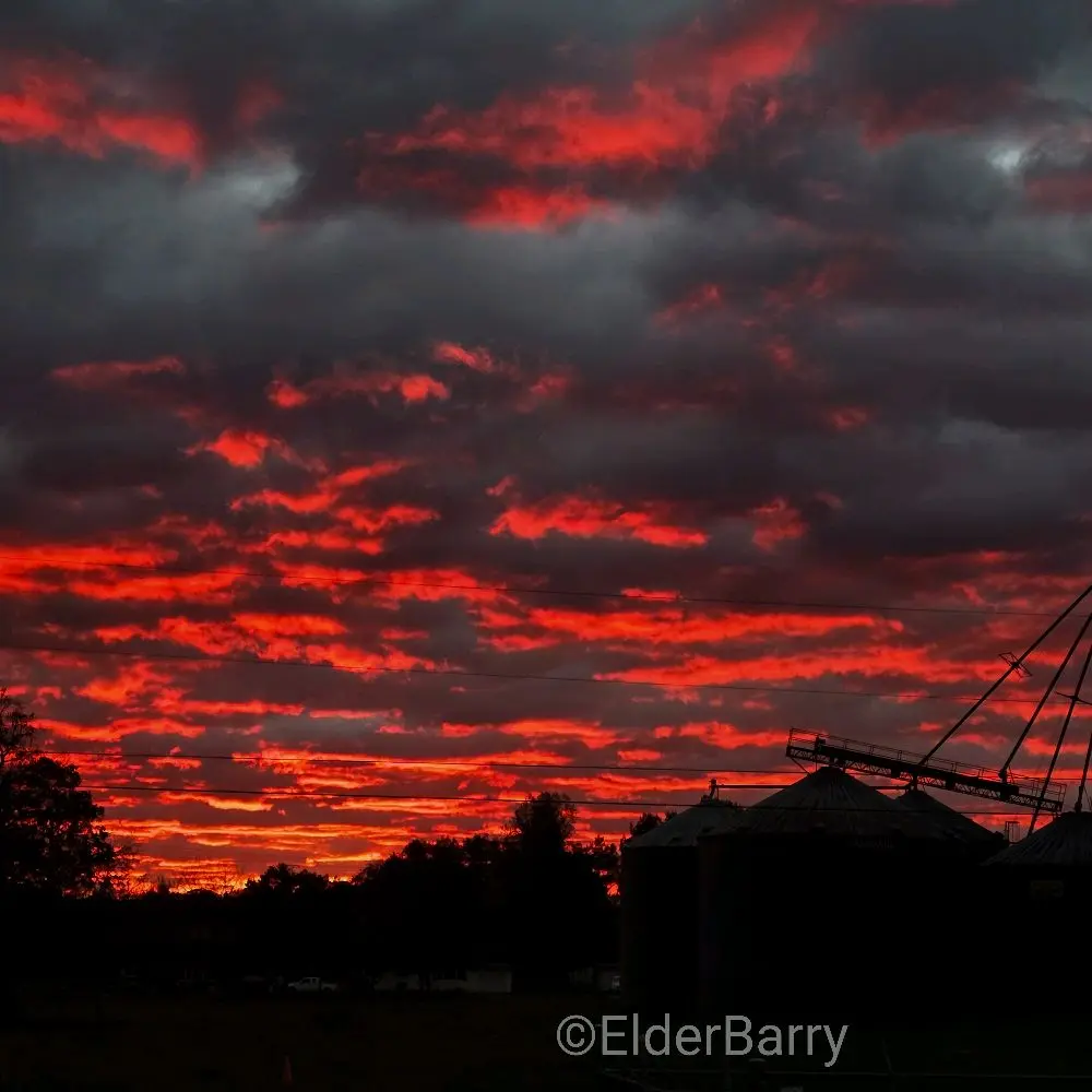 Elder Barry Photography - Captivating Red Sky Sunset Scene with Silhouetted Silos and Dramatic Clouds for Artistic Wall Decor