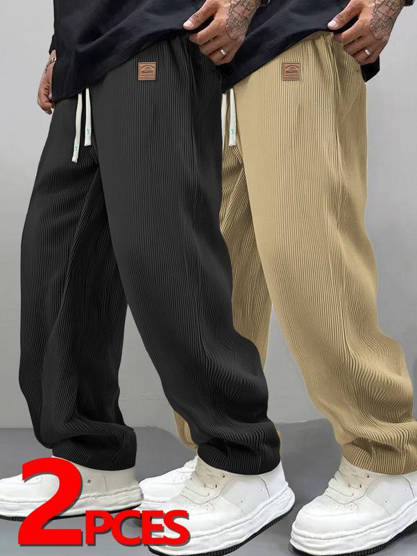 Two men's autumn casual pants featuring a simple and versatile style with drawstring design, adding a casual feel. The pants have delicate small details, such as stitching accents, making them comfortable and stylish. The loose fit provides comfort and fr