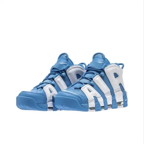 Classic two-tone blue white athletic shoes, vibrant blue leather base, bold white 3D letter panels, blue laces and thick blocky segmented rubber sole.