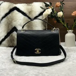 Pre-owned CHANEL V patterned black and gold crossbody bag