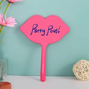 Petty Pout! Lip shaped mirror with pink handle.